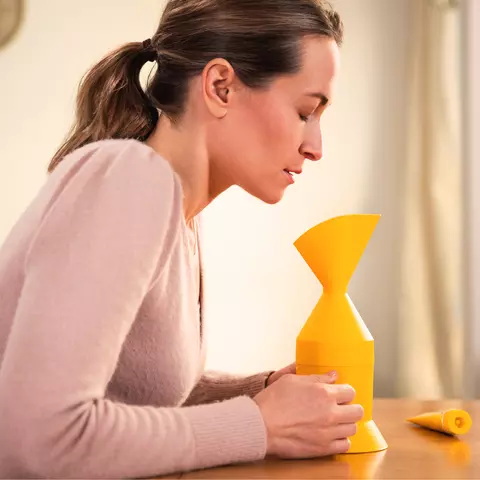 Frau inhaliert mit dem Inhalator